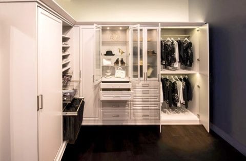 High End Closet In Room With Slate Blue Accent Wall